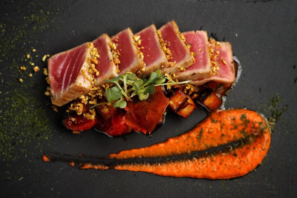 SEARED TUNA IN PISTACHIO CRUST WITH SWEET PEPPERS CREAM AND SICILIAN CAPONATA